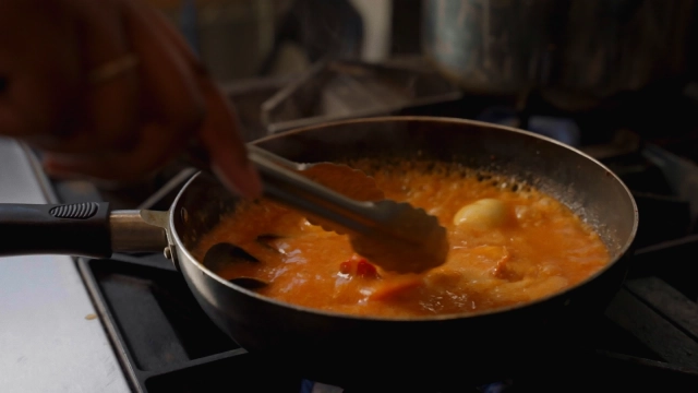 Lobster tails cooking in a sauce pan